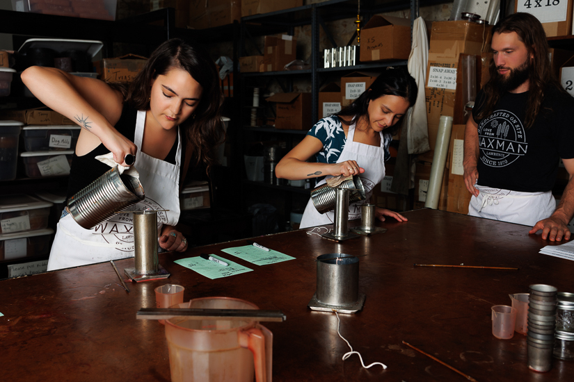 Waxman5789E Class instructor, Ryder, watches over two participants while making candles in Waxman's studio.